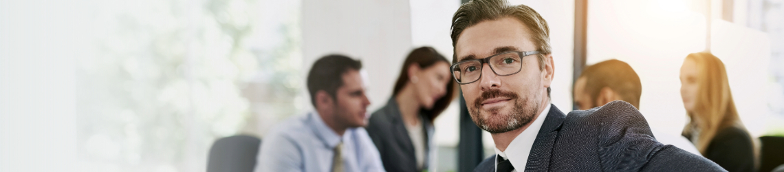 Image of two people collaborating over paperwork
